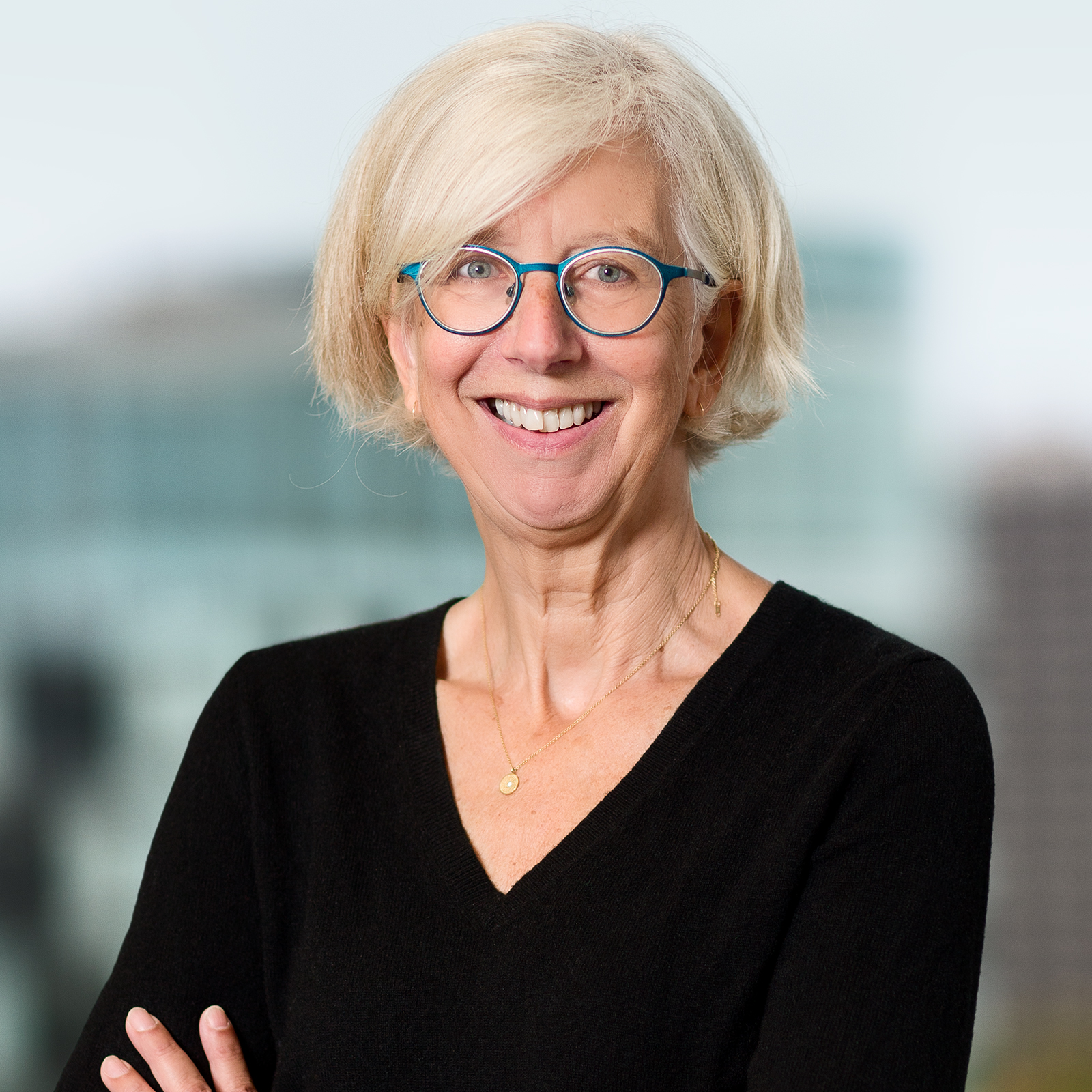 A photograph of a white woman with white hair cut into a bob and glasses, wearing a black shirt. The portrait is a business headshot of Monica Heller, president of CASCA.